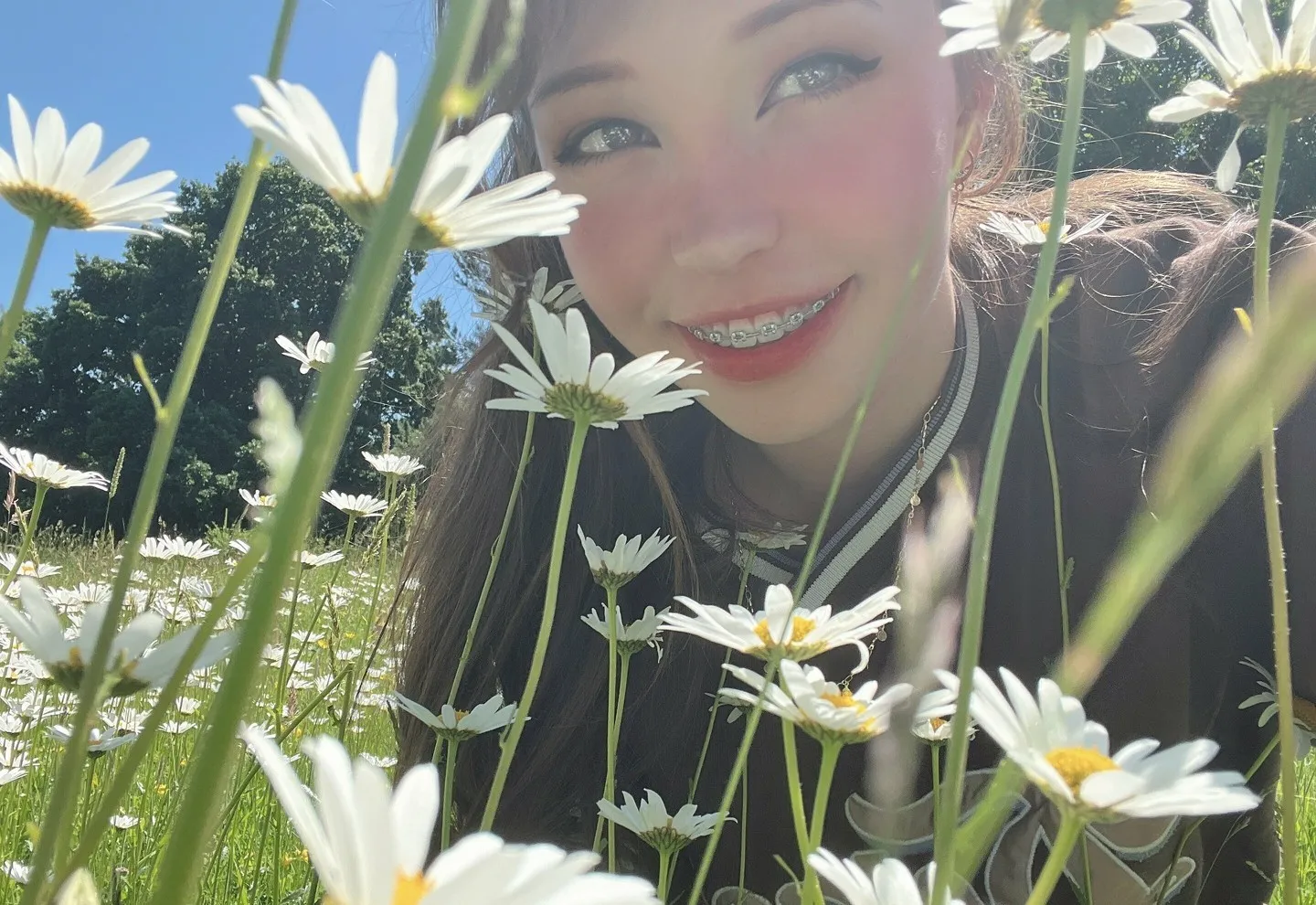 BelleDelphine在雏菊草地中近距离面对镜头微笑