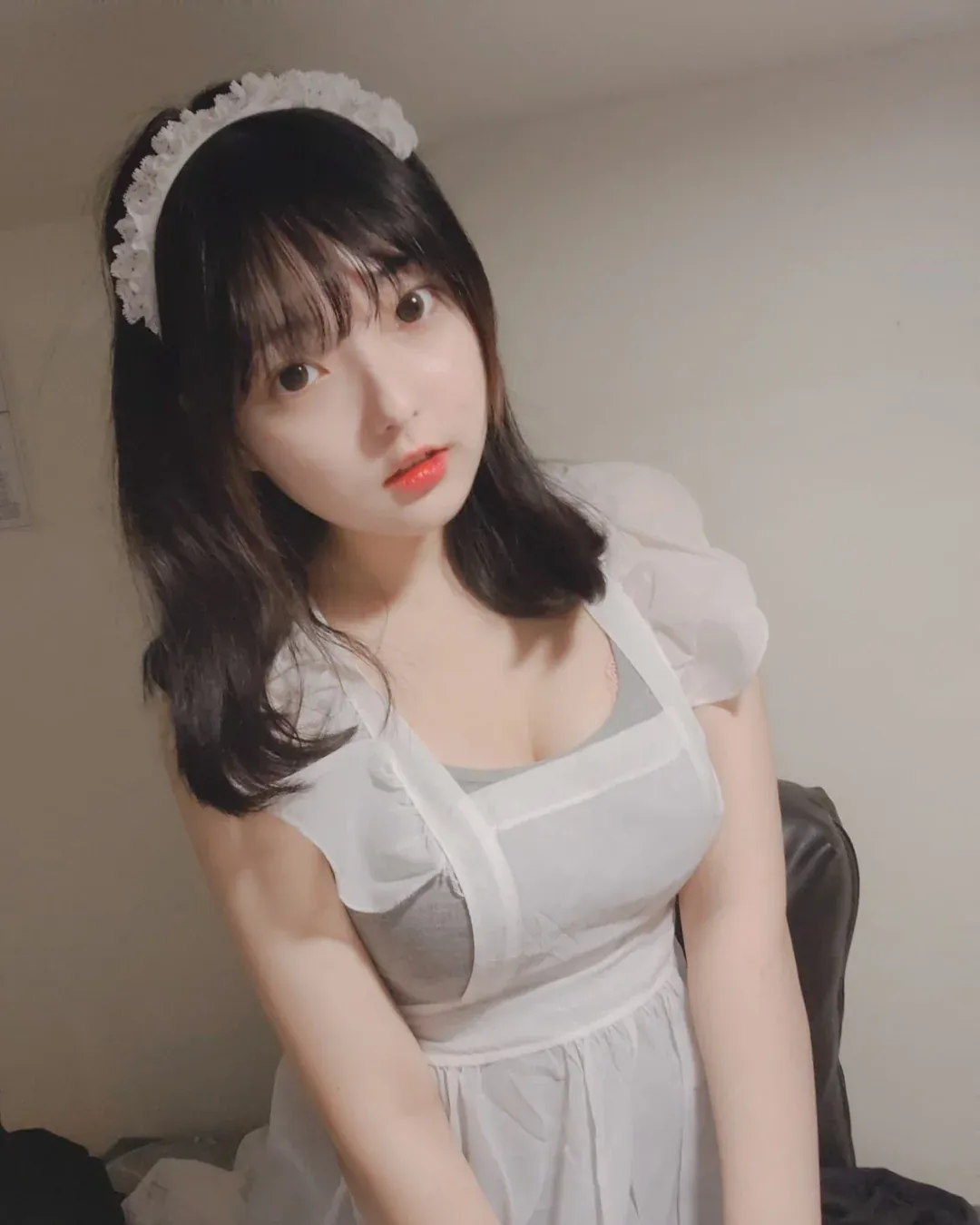 Hansom(한솜)黑色中长发,戴白色头饰,穿白色女仆风服装坐在床边的写真